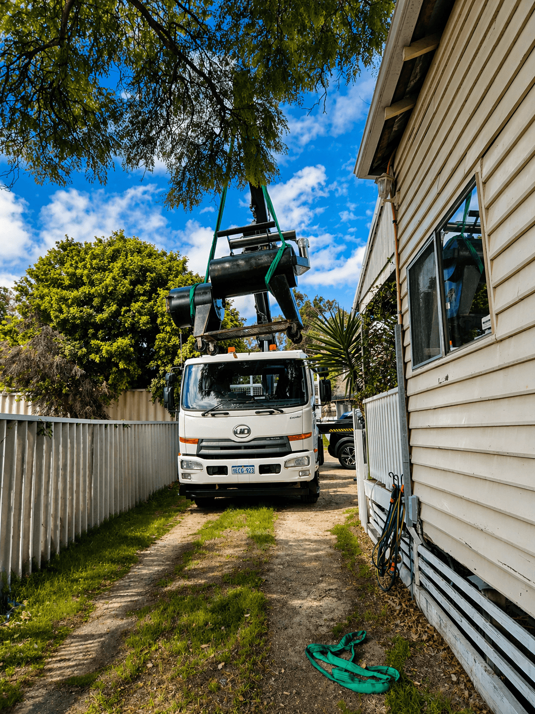 Susa Cranes HIAB lifting equipment over a Perth house from a side passage